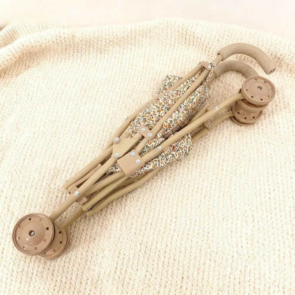 Poussette pliable de haute qualité pour poupée avec motif de fleurs.